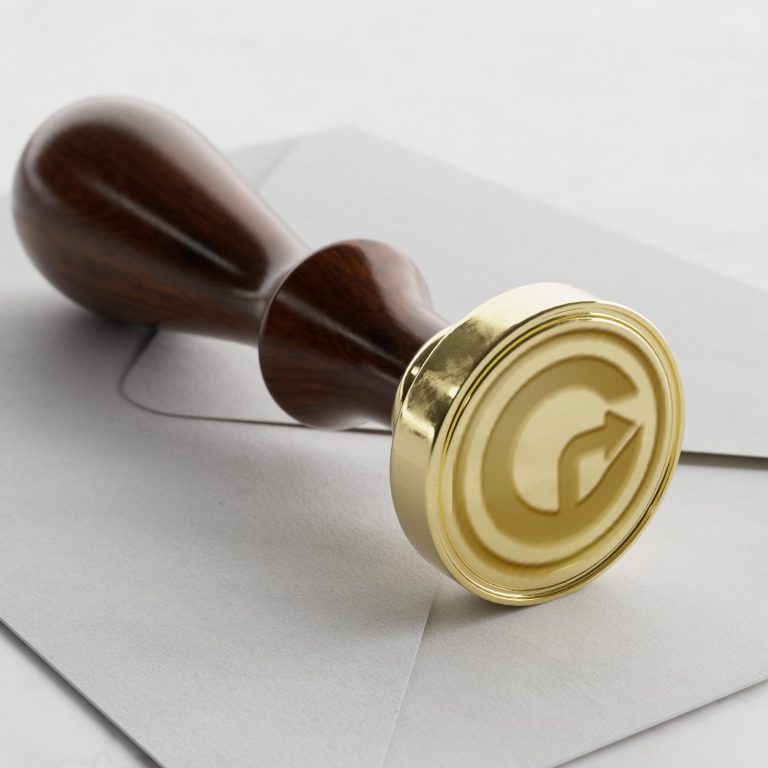 Wachssiegel mit einem stilisierten Buchstaben "G" auf einem Umschlag.